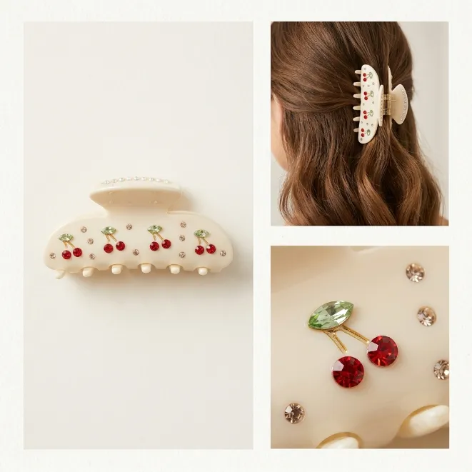 Cream white acetate hair claw clip with red rhinestone cherry motifs and sparkling crystals